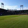 Green grass of Huntington Park baseball field with stands