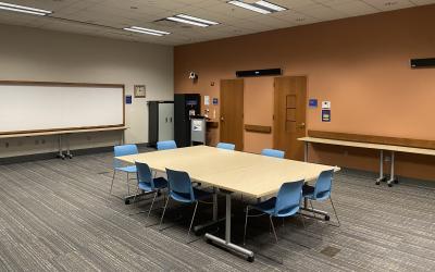 Tables and chairs set up in the Trillium Meeting Room