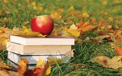 Apple on top of a stack of books