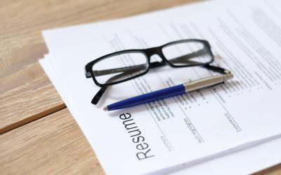 Resume on a table with a pen and glasses