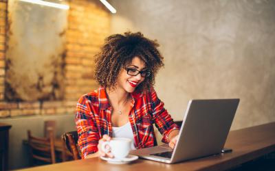 Woman enjoying what she sees on her laptop