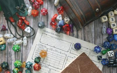 Tabletop board game die, pouches and character sheet